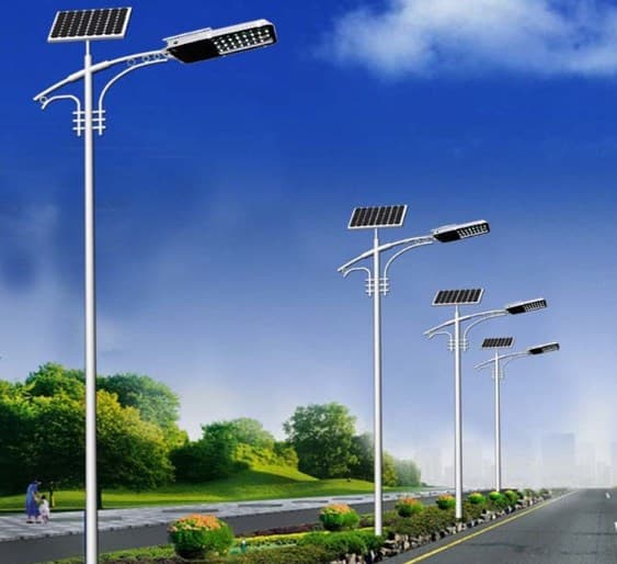 Illuminated solar-powered sign along a roadway at dusk