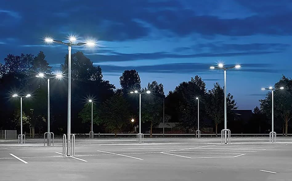 Solar-powered light poles illuminating a commercial parking lot