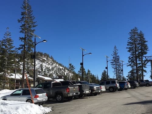 Solar light installation in a snowy parking lot