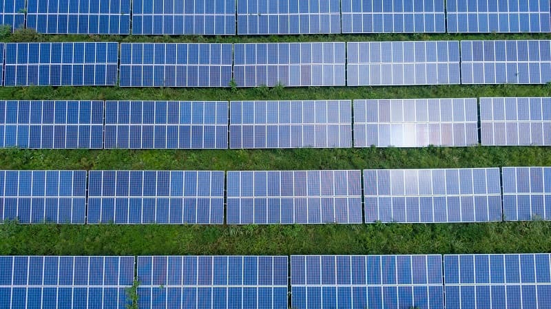 Stack of retired solar panels awaiting recycling