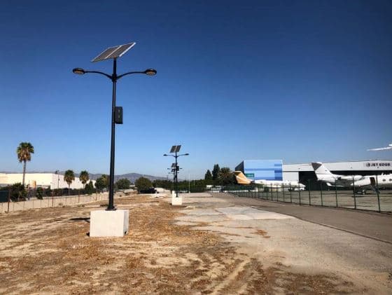 Solar-powered parking lot lights illuminating a lot at night