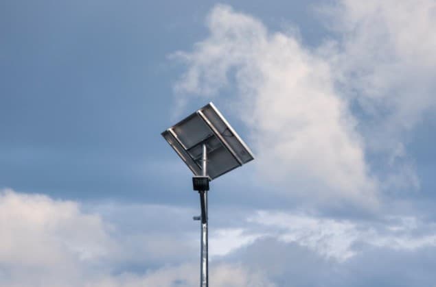 Solar panel street light along a roadway